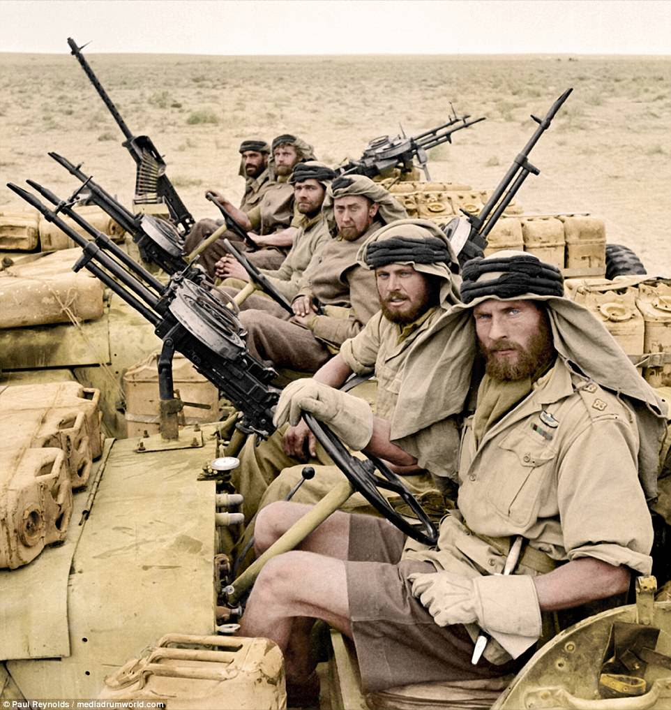 Six fierce-looking SAS troops sit in jeeps while on a mission in the North African desert. A knife can be seen in the belt of the man at the front, while machine guns can be seen mounted on the back and front of their vehicles