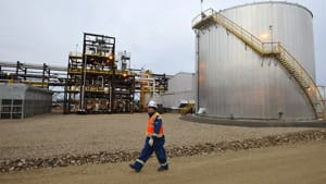An oilfield worker walks past the Statoil oilsands facility near Conklin, Alta. A European Union proposal would officially label fuel from the oilsands as dirty because it results in 22 per cent more greenhouse gas emissions than conventional sources.