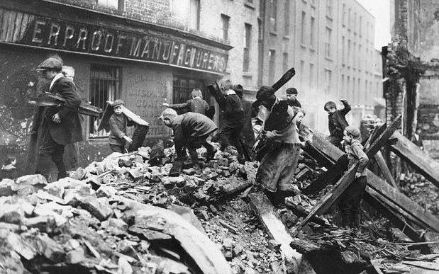 Children collect firewood from the ruined buildings damaged in the Easter Rising