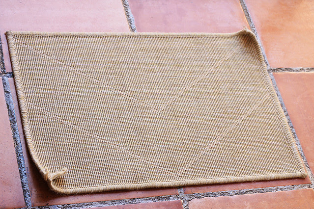 Otherwise fine IKEA doormat with curling, fraying edges