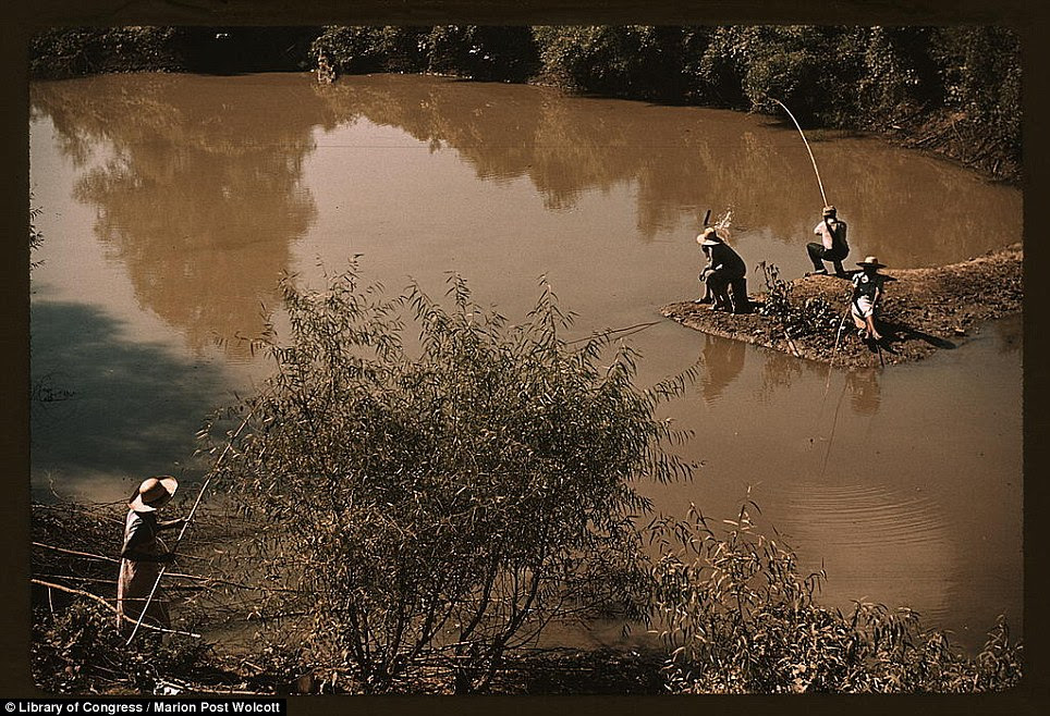 Men fishing at a creek near cotton plantations outside Belzoni, Mississippi 