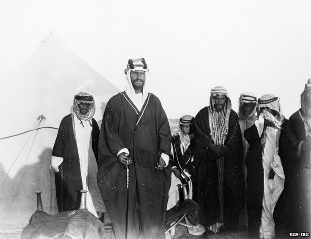 Ibn Saud standing in front of his son and followers near Thaj 1911