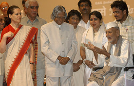 Bismillah Khan gestures as Indian President A.P.J. Abdul Kalam, BJP leader Jaswant Singh and Congress president Sonia Gandhi look on prior to a concert at Parliament House in New Delhi