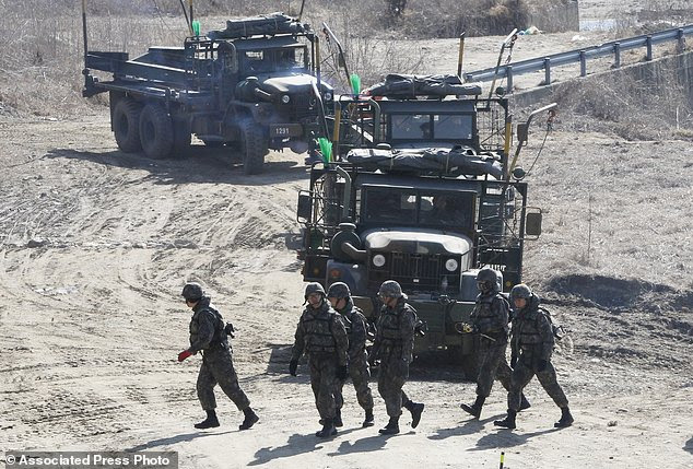 South Korean army soldiers prepare to conduct a river crossing operation near the Hantan river in Yeoncheon, near the border with North Korea, South Korea, Monday, March 6, 2017. North Korea on Monday fired four banned ballistic missiles that flew about 1,000 kilometers (620 miles), with three of them landing in Japan's exclusive economic zone, South Korean and Japanese officials said, in an apparent reaction to huge military drills by Washington and Seoul that Pyongyang insists are an invasion rehearsal. (AP Photo/Ahn Young-joon)