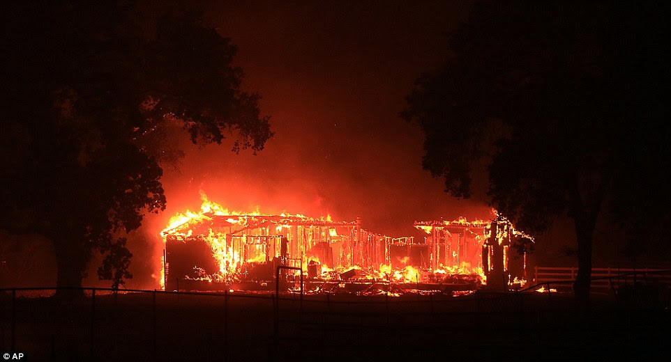 A home burns along Highway 29 in Hidden Valley during the Valley fire, which was still raging on Sunday night 