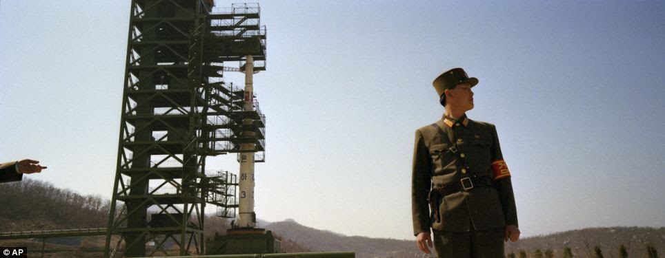 On guard: Soldiers stand guard in front of the country's Unha-3 rocket at Sohae Satellite Station in Tongchang-ri, North Korea. The Kwangmyongsong-3 satellite was launched on April 13, 