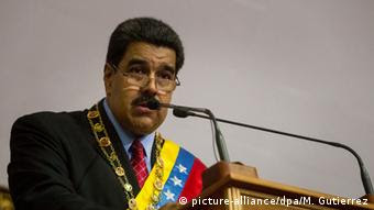 Venezuelan President Nicolas Maduro, wearing a sash, delivers a speech