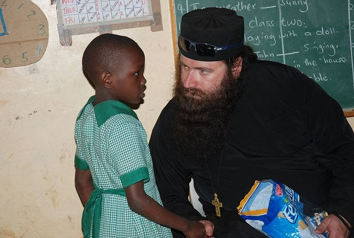 Fr. Silouan having a heart to heart with one of the children at St. George's Education Center and Kibera Slums