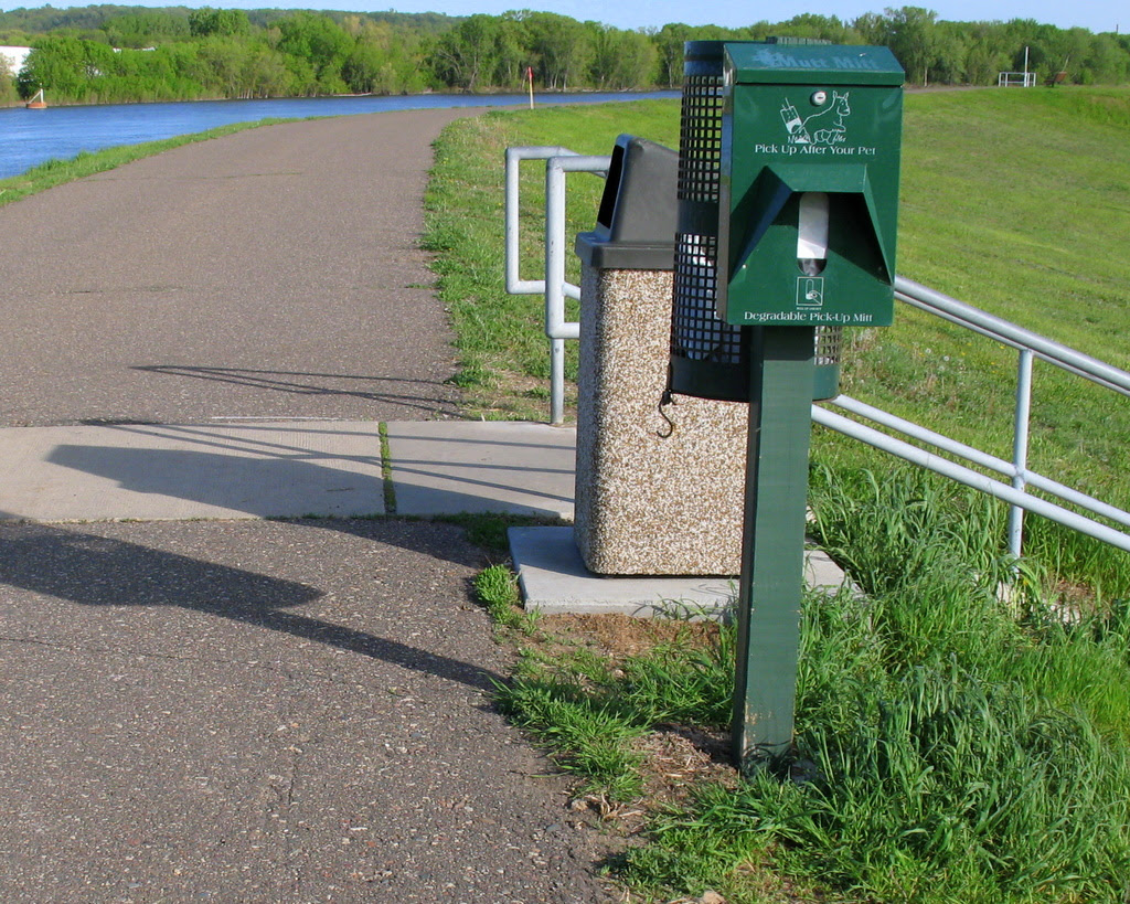 the poop removal dispenser machine on a walking path