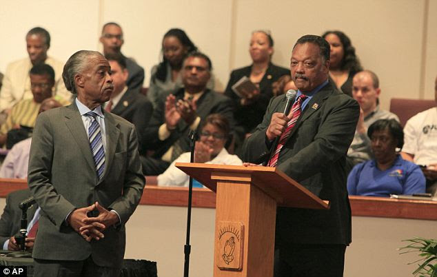Anger: Rev Jesse Jackson, right, speaks as Rev. Al Sharpton listens during a community forum on slain Florida teenager Trayvon Martin at the Macedonia Baptist Church in Eatonville, Florida