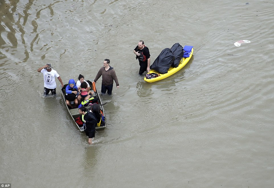 People have been forced to use kayaks and small boats to navigate their way through the floods in Houston 