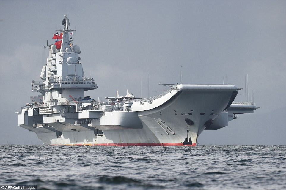 China's first aircraft carrier sailed into Hong Kong waters today, its latest show of growing military might at a time of rising regional tension