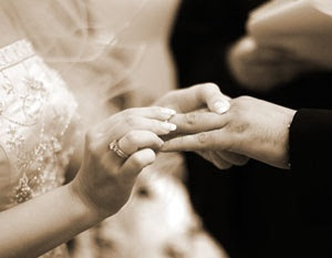 I LOVE this photo. I think all wedding photos should include the traditional exchanging of rings and vows :D