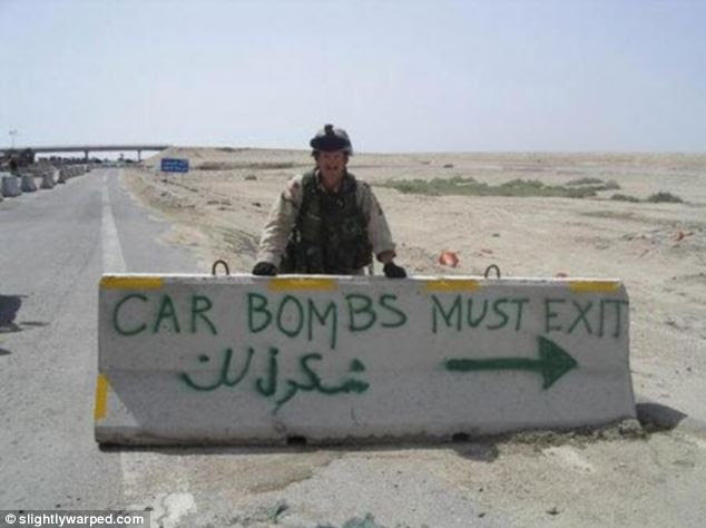 Diversion: Soldier stands behind this roadblock marked with some wishful thinking