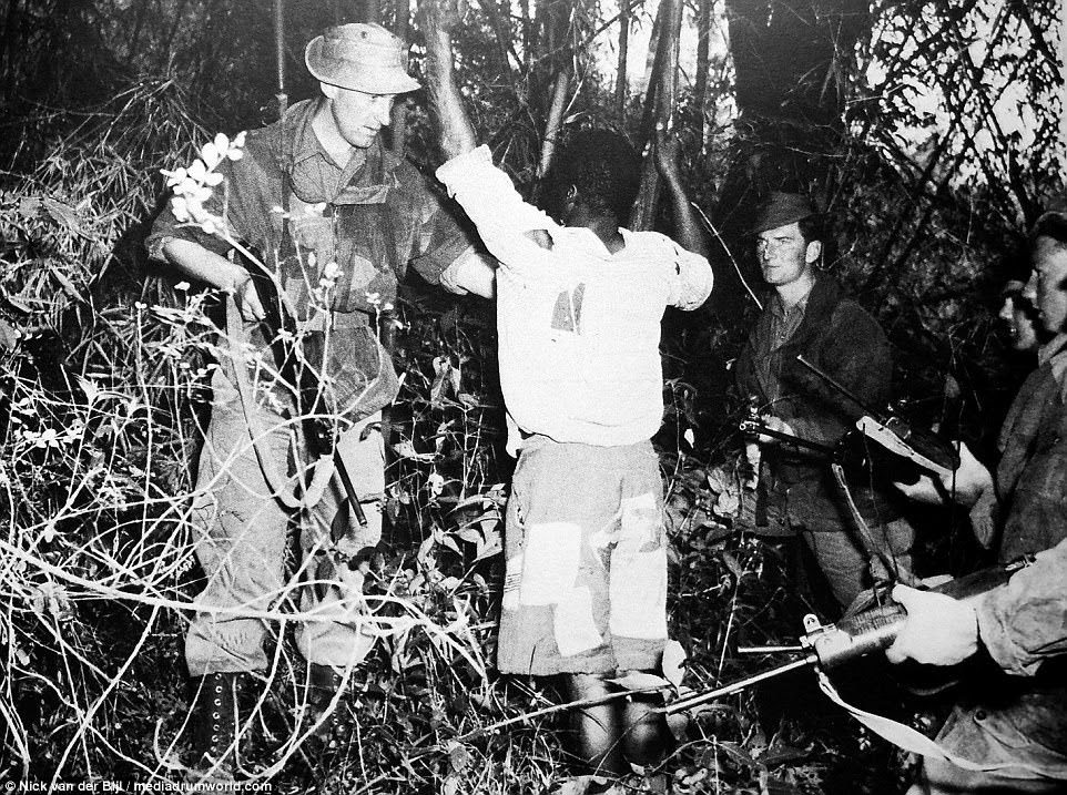 A soldier searches a Mau Mau suspect in the depths of the semi-tropical forest, where rebel forces would ambush British and African soldiers. The striking images were captured during British counter-insurgency operations in Kenya between 1952 and 1956