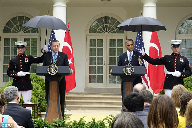 Broken Regulations: US Marines hold umbrellas during light rain for US President Barack Obama and Turkish Prime Minister Recep Tayyip Erdogan during a joint news conference today