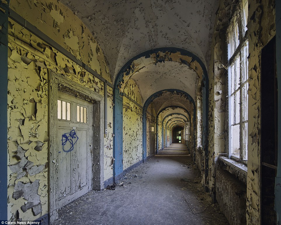 PIC BY DANIEL BARTER / CATERS NEWS - (PICTURED: Lung sanatorium) - Even the powerhouse of Europe has its fair share of abandoned properties and empty shop fronts as seen in these captivating pictures of decaying buildings Germany. Photographer Daniel Barter, 30, from London travelled Berlin and the surrounding countryside to capture buildings in need of work on film. Far from being resplendent in vintage glory, the deserted music venues and crumbling hospitals are a shadow of their former selves. German eagle motifs flake off ceilings and concert halls designed for hundreds have not seen a show for years. SEE CATERS COPY.