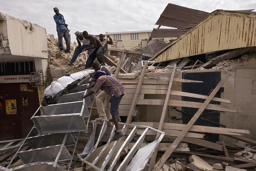 Haitians Retrieve Deceased from Collapsed Building by United Nations Photo.