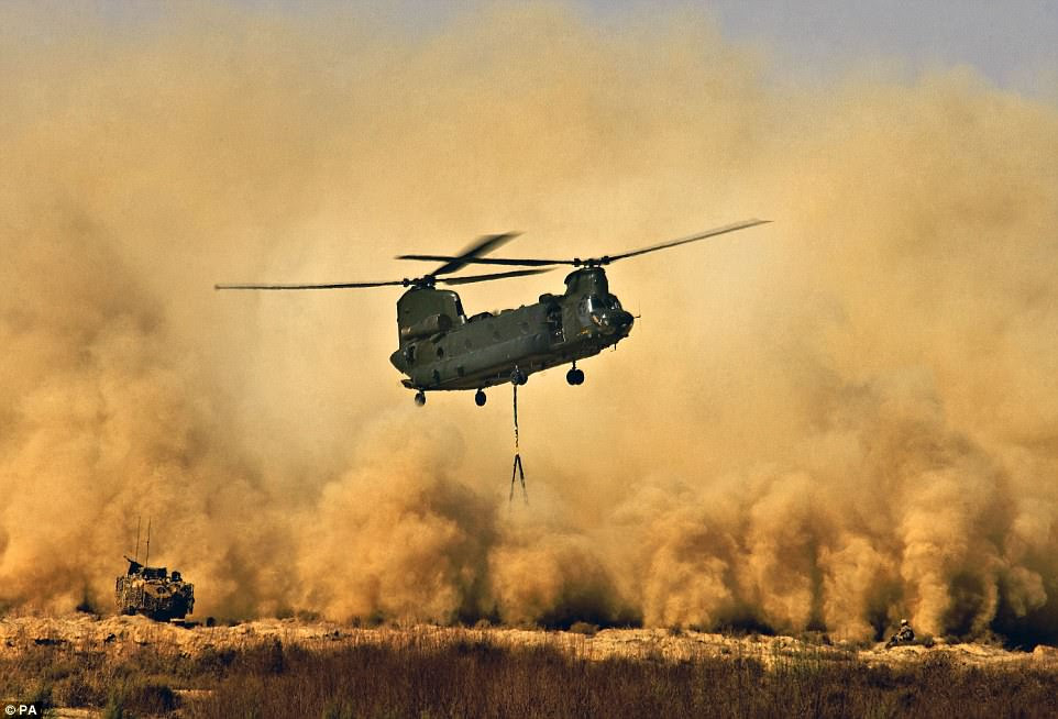 Royal Air Force CH47 Chinook Helicopter creating a dust storm during the re-supply of the men of 42 Commando Royal Marines at Patrol Base Delhi