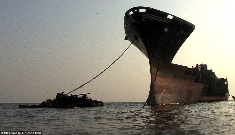 Wounded giant: This splintered vessel was photographed rising from the water off Jafrabad, Bangladesh.