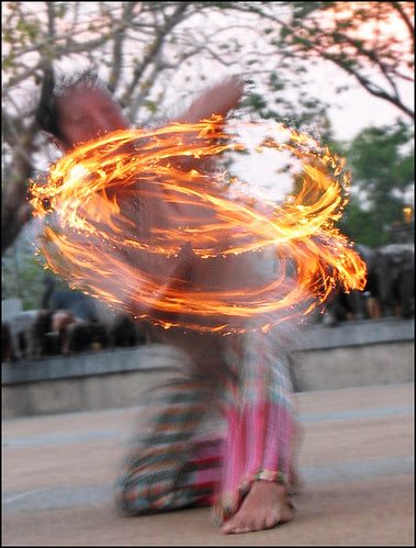 Sunset fire dancer at Cape Phromthep