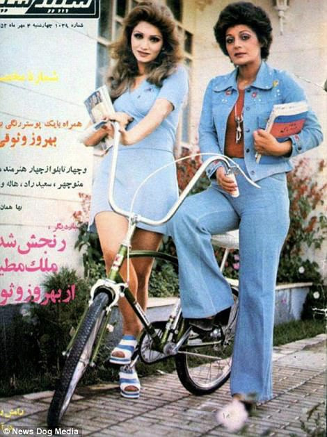 Two women in fashionable 1970s clothing pose up for a magazine ad