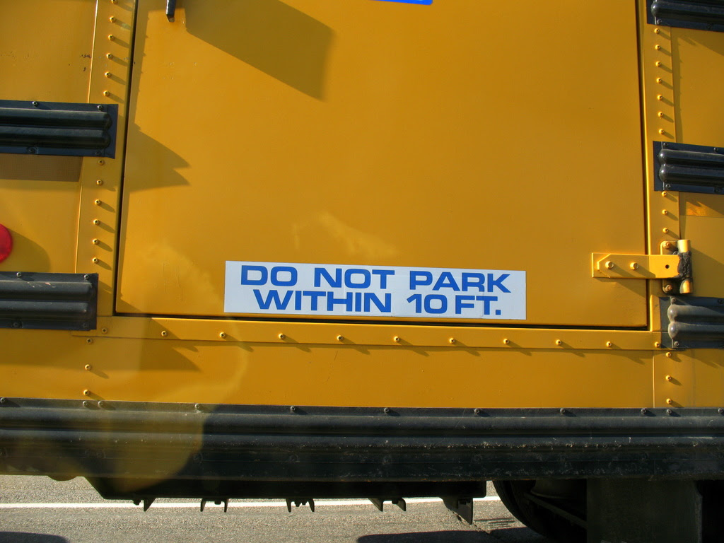 A warning sticker on a school bus, do not park within 10 feet.