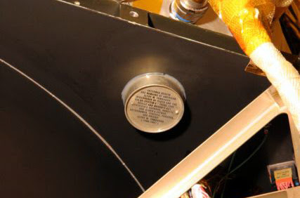 This undated photo provided by Johns Hopkins University Applied Physics Laboratory via NASA shows an aluminum canister containing the ashes of Clyde Tombaugh, the American astronomer who discovered Pluto in 1930, attached to NASA's New Horizons spacecraft. On Tuesday, July 14, 2015, the spacecraft is scheduled to pass within 7,800 miles of Pluto which he discovered 85 years ago. (Johns Hopkins University Applied Physics Laboratory via AP)