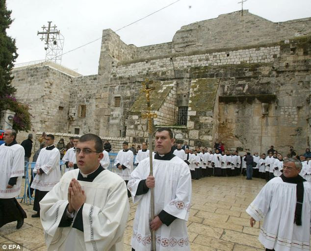 Venerated: Christians march at Manger Square outside the Church of the Nativity in the Biblical town of Bethlehem