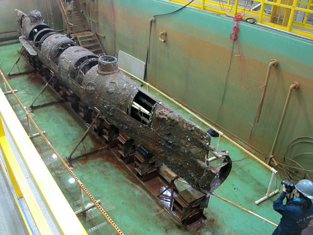 The Confederate submarine H.L. Hunley sits in a conservation tank at a conservation lab in North Charleston, South Carolina
