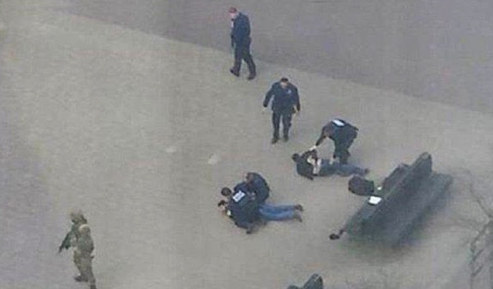 Drama: Two men were pinned to the ground by armed police and special forces as the hunt for members of the terror cell behind today's bombings in Brussels started