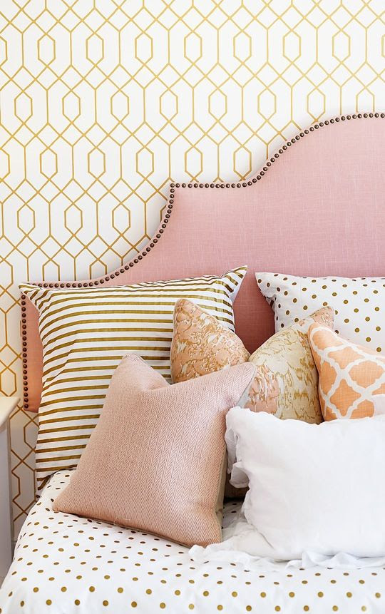 coral, pink and gold girl's room. pattern mix. upholstered headboard with nailhead detail.