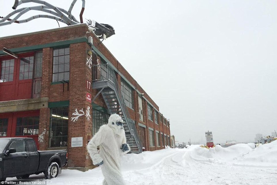 Peculiar sight: A man in a furry white suit jogs through the snow in Boston after a winter storm dumped 16.5 inches of snow on the city