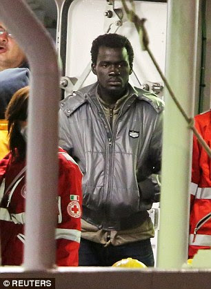 Haunted: A surviving immigrant who escaped the boat that capsized in the Mediterranean Sea killing up to 900 people appears deep in thought as he arrives in the Sicilian port city of Catania this morning