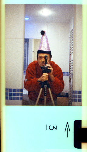 reflected self-portrait with Voigtlander Vitoret 110EL camera and Xmas hat from Poundland by pho-Tony