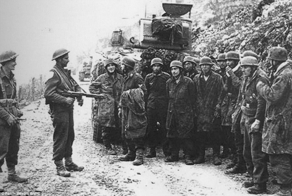 The author of the book has also highlighted little-known atrocities committed by Moroccan irregular mountain troops of the French Expeditionary Corps upon Italian citizens throughout the course of the Italian campaign, especially after the Battle of Monte Cassino. Pictured above, soldiers are taken prisoner after the bombing of 15 March are guarded by soldiers of the 2nd NZ Division behind a Sherman tank