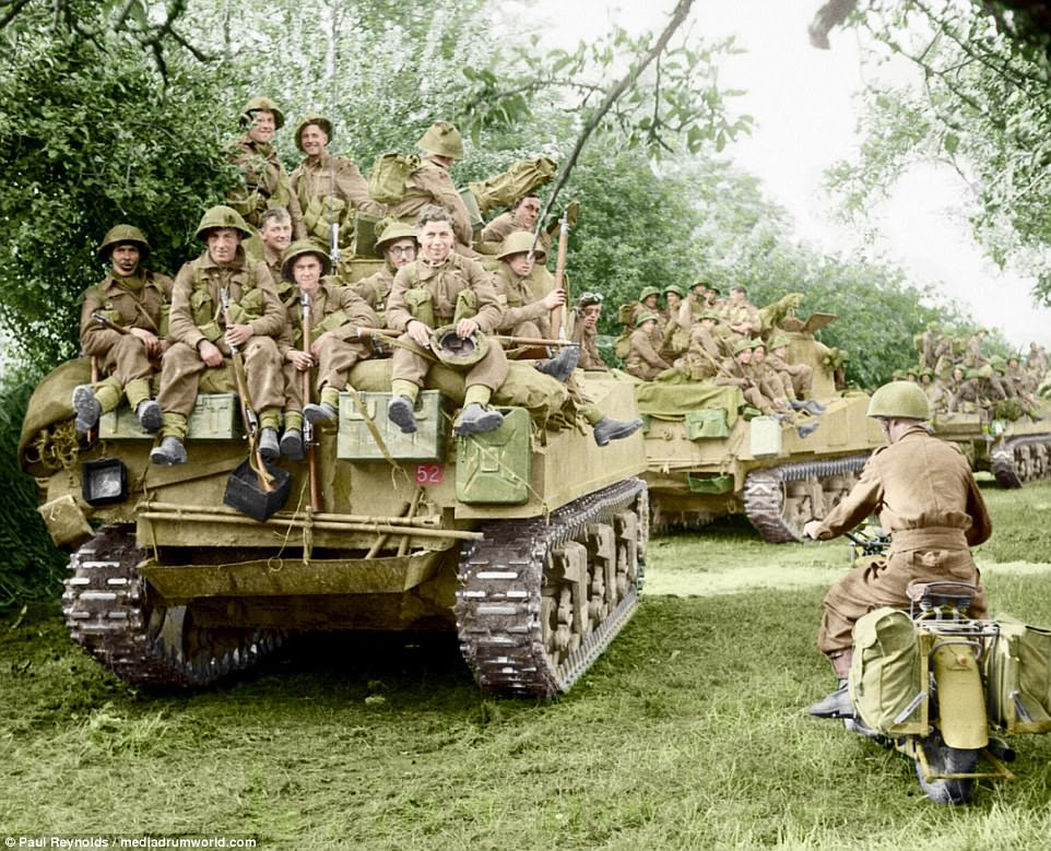American-built Sherman tanks of the Staffordshire Yeomanry, 27th Armoured Brigade, carrying infantry from the Third Division, move up at the start of Operation Goodwood, Normandy, on July 18, 1944. Goodwood, which occurred between July 18 and 20 in Normandy, involved an estimated 1,100 British tanks and several hundred Nazi tanks. It is believed to be one of the biggest tank battles in British military history, with hundreds of British armoured vehicles being destroyed and nearly 3,500 troops being killed or wounded