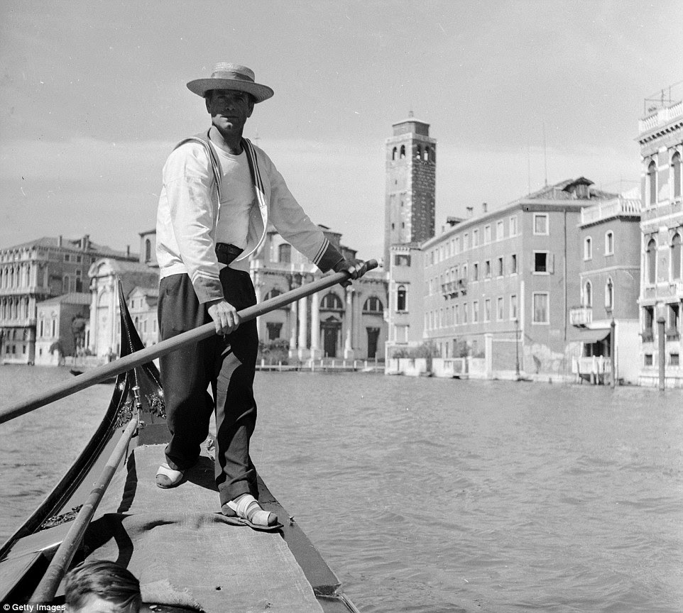 City of romance: A gondolier navigates his way through Venice, in front of St Mark's square circa 1950