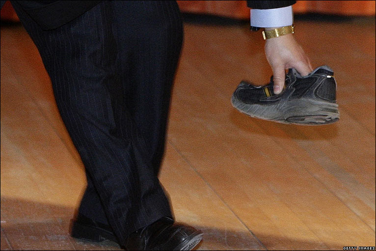 Security guard picks up shoe at Cambridge University on 2 Feb 2009