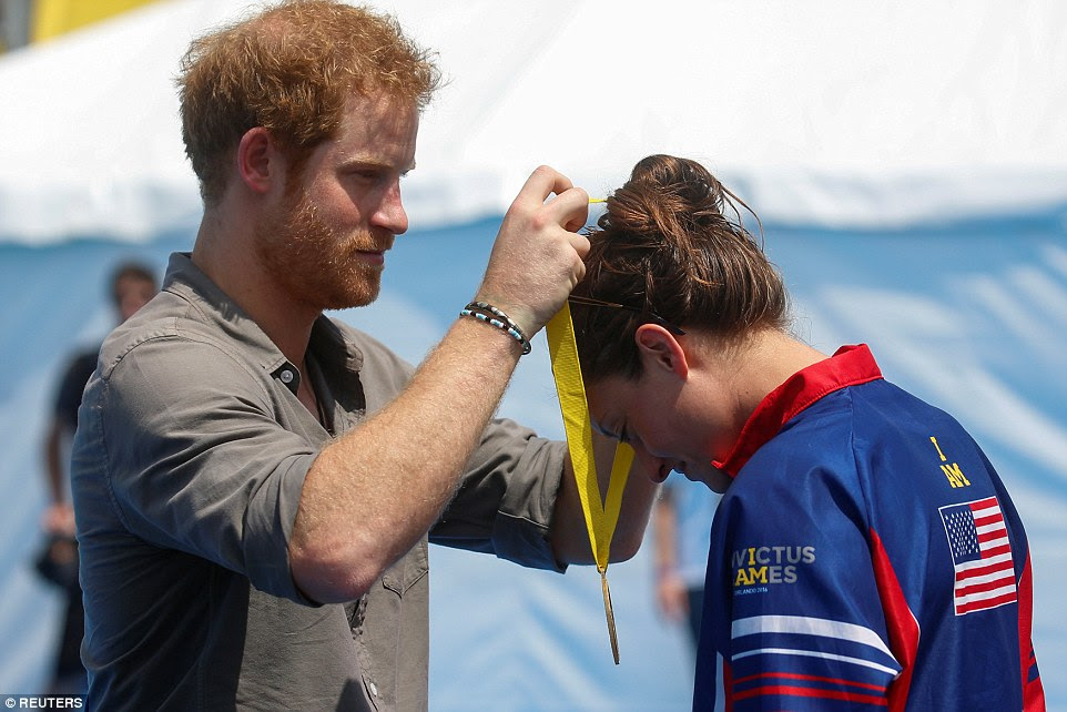 Elizabeth took home the gold for the US in the swimming finals but asked Harry to take the medal back to the hospital in Cambridge that cared for her after she became gravely ill when she collapsed with a serious lung condition and was put into an induced coma