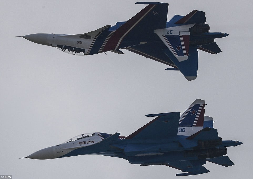 The Russian Knights' are seen taking to the skies during an aerobatic demonstration by the Russian Air Force earlier today. Pictured is the Sukhoi Su-30SM fighter aircraft