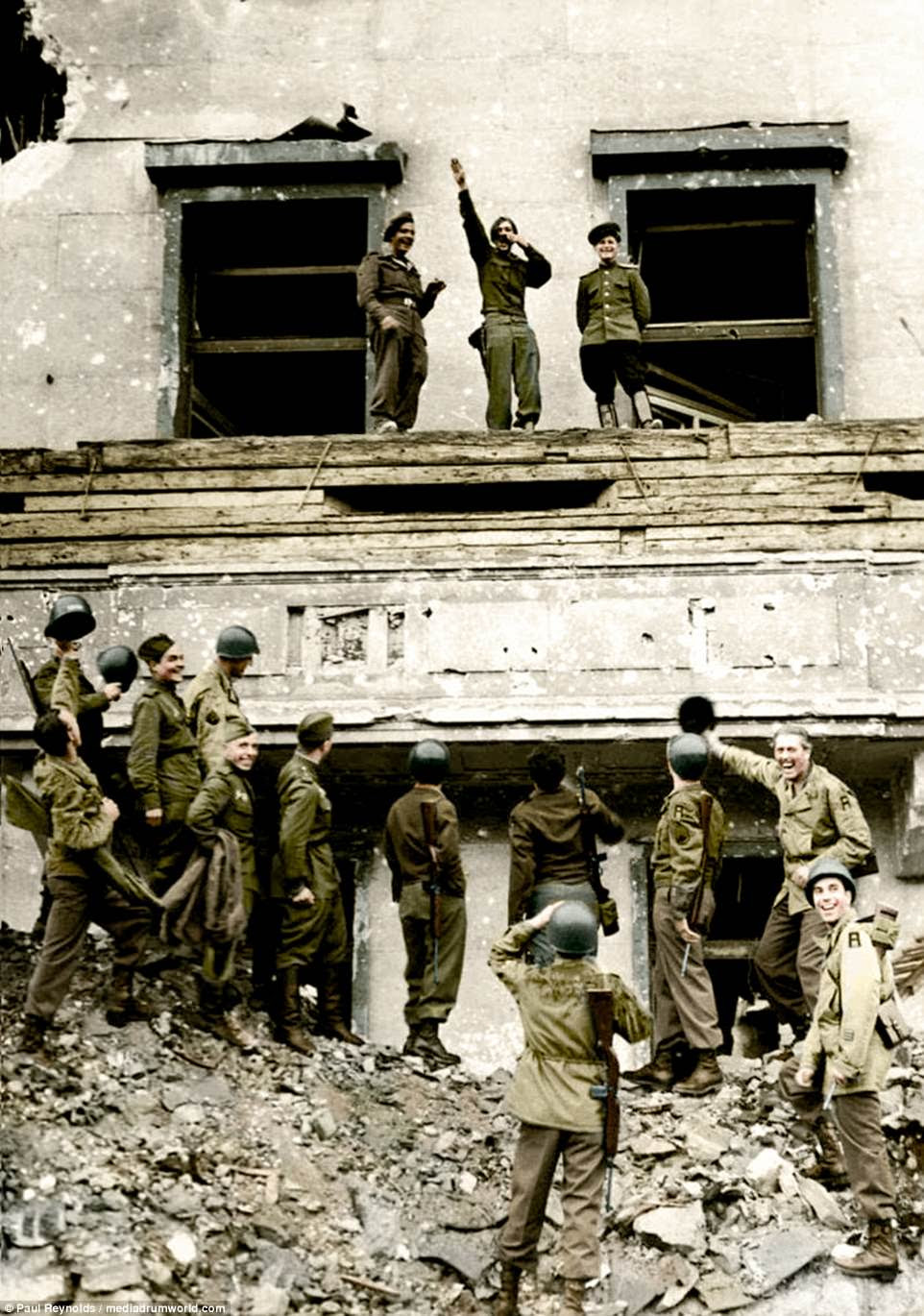 Revenge: The final victory over Nazi Germany achieved, soldiers and allies of the British, American and Russian armies mimic and mock Adolf Hitler and his ideas on the dictator's famous balcony at the Chancellery in conquered Berlin on July 6, 1945