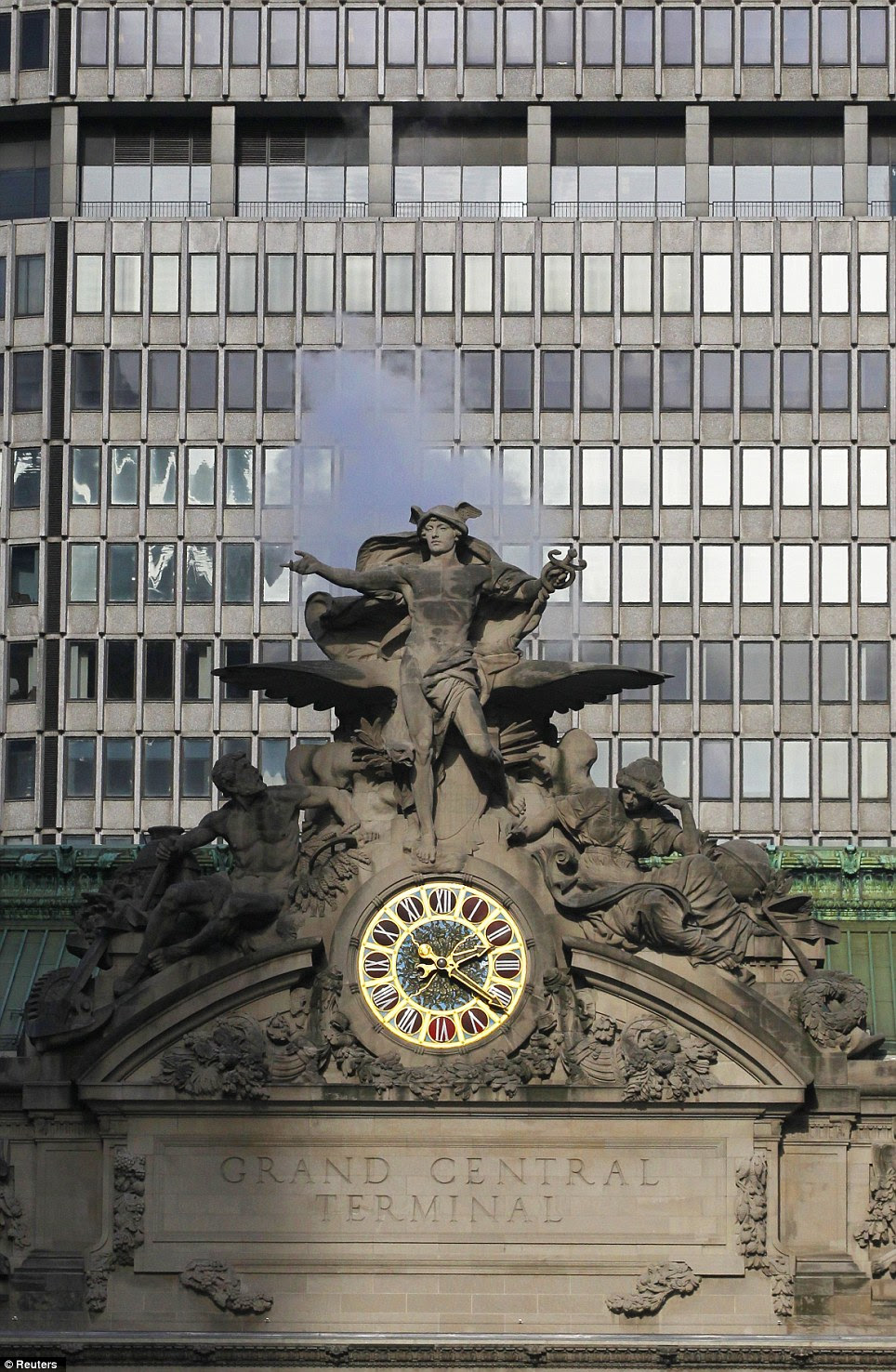 Steam rises behind the sculptures by the John Donnelly Company of Minerva, Hercules, and Mercury over Park Ave and 42nd St. at Grand Central Terminal