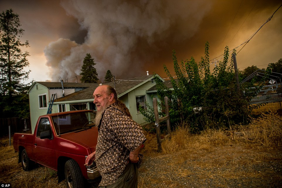 Martin Lawson, who has lived in Sheep Ranch for over 40 years, watches a fire approach his property as people start to give up hope and flee