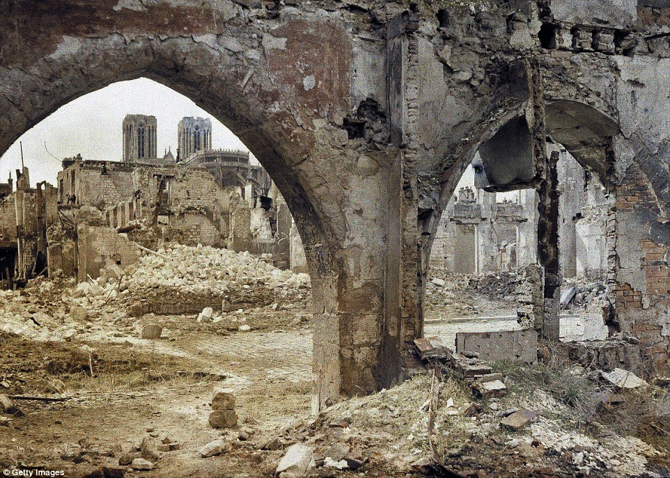 The towers of the Cathedral Notre-Dame de Reims  can be seen through the damaged windows of a building in the city in 3 April 1917