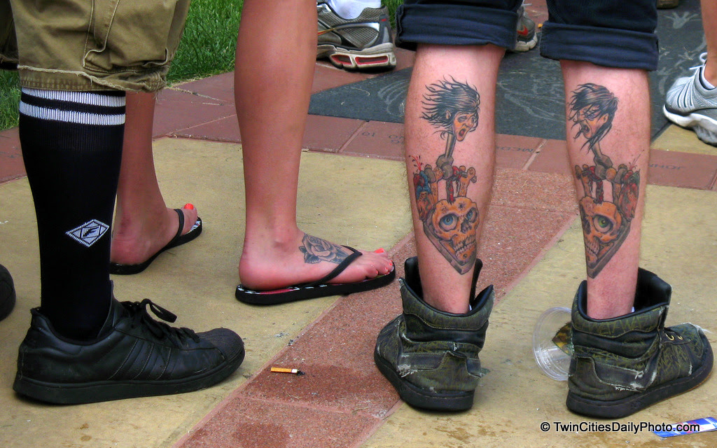 The tattooed legs caught my eye initially, but take another look....which is more shocking, the tattooed legs or the legs wearing shorts and over the calf socks? I mean really?