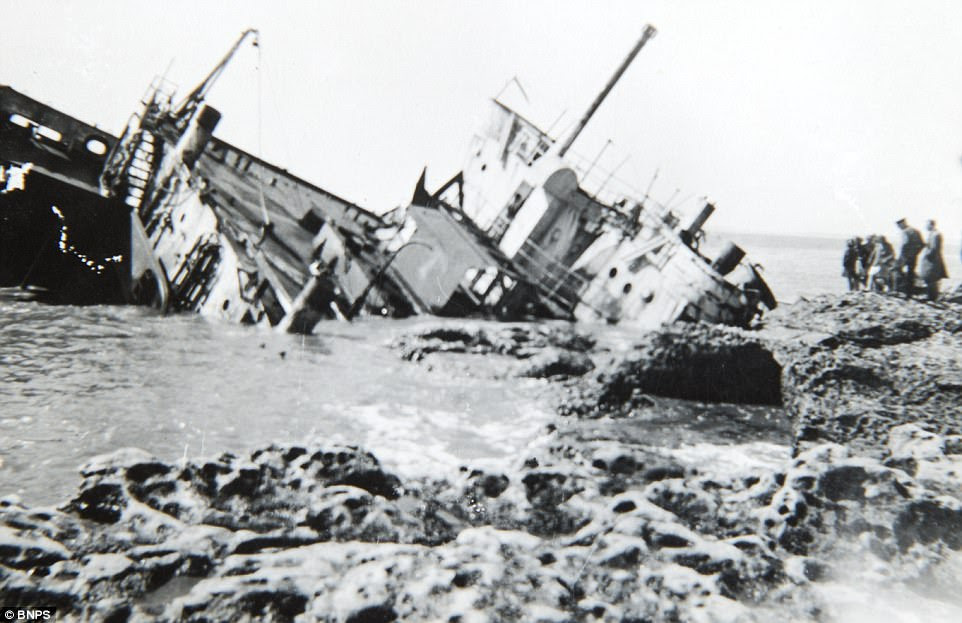 Haunting photographs taken behind enemy lines that capture the trail of devastation left in the wake of the Dunkirk evacuation have been unearthed after 77 years. Pictured, a shipwreck on the beach in La Panne