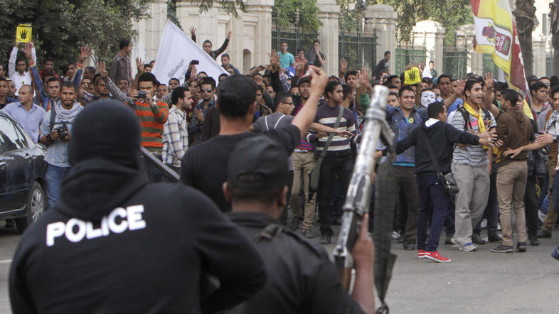 Egyptian police facing pro-Morsi protesters in Cairo in Nov. 2013