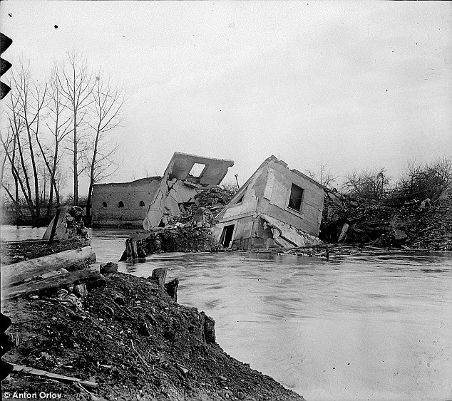Time capsule: A French camera dating back to WWI has revealed this never-before-seen photograph of a crumbled, war-torn building into a river, as one of eight photos