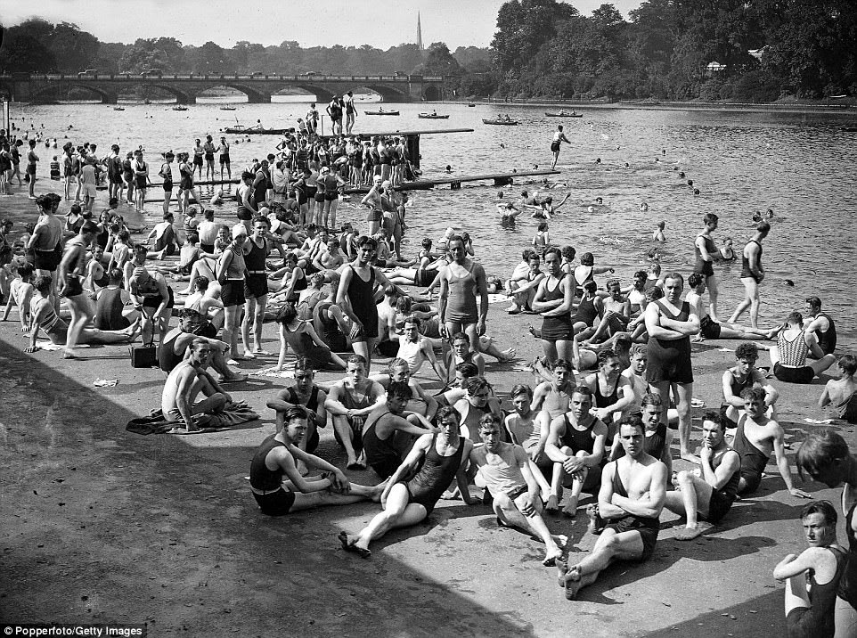 A crowd of people wearing swimwear bathing in the Serpentine during the high temperatures in London's Hyde Park in August 1930